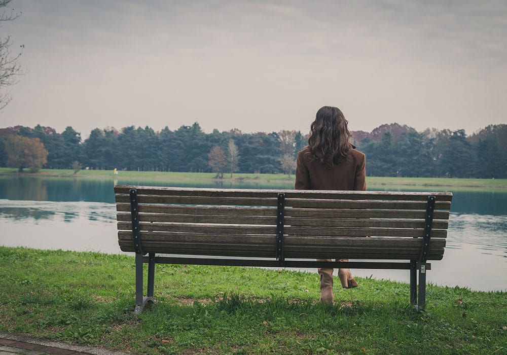 The importance of feeling vulnerable, picture of woman on a park bench, feeling vulnerable